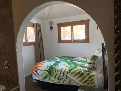 a bedroom with a bed with a colorful comforter at Chantico Inn in Ojai
