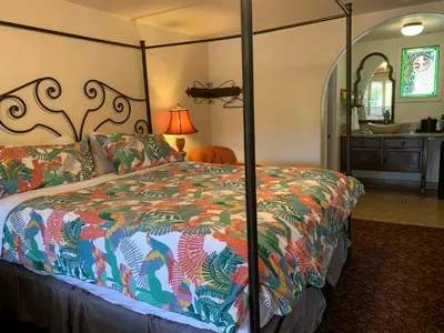 a bedroom with a bed with a colorful comforter at Chantico Inn in Ojai