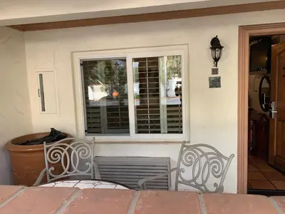 a porch with a bench and a window at Chantico Inn in Ojai