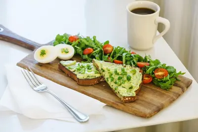 a plate of food with eggs and bread and vegetables at Courtyard by Marriott Los Angeles Woodland Hills in Woodland Hills