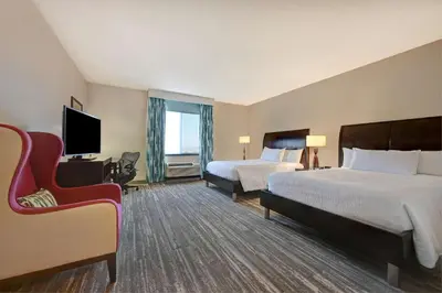 a hotel room with two beds and a tv at Hilton Garden Inn San Bernardino in San Bernardino