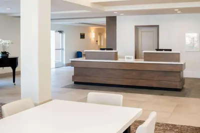 a lobby with a reception desk and a piano at Hilton Garden Inn Fontana in Fontana