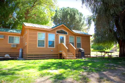 a small house with a picnic table in front of it at Soledad Canyon Cottage 2 in Ravenna