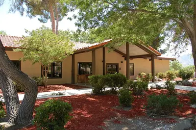 a house with a tree in front of it at Soledad Canyon Cottage 5 in Ravenna