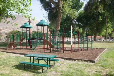 a park with a playground with a slide and benches at Soledad Canyon Cabin 18 in Ravenna