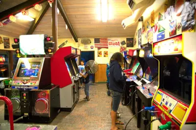 two people playing video games in a arcade at Soledad Canyon Studio Cabin 19 in Ravenna