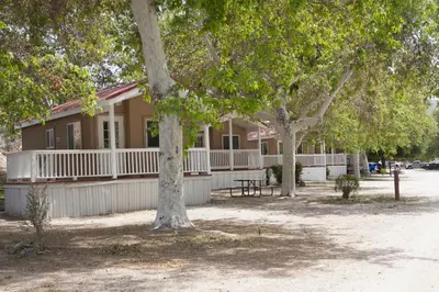 a building with trees in front of it at Soledad Canyon Studio Cabin 19 in Ravenna