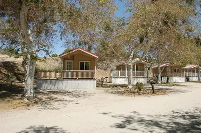 a house in the middle of a field with trees at Soledad Canyon Studio Cabin 21 in Ravenna