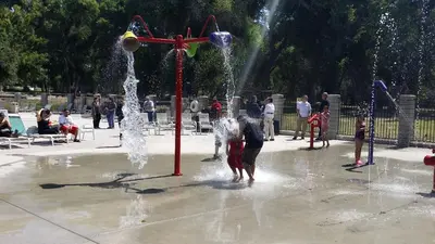a group of children playing in a fountain in a park at Soledad Canyon Deluxe Cabin 23 in Ravenna
