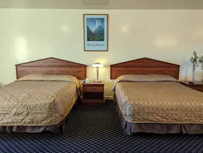 a hotel room with two beds and a picture on the wall at Americas Best Value Inn Oxnard-Port Hueneme in Port Hueneme