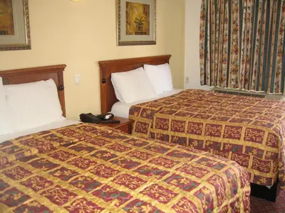 a hotel room with two beds and a telephone at Tower Motel Long Beach in Long Beach