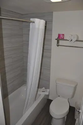 a bathroom with a toilet and a shower curtain at Motel 6 Maple/Main in Hesperia