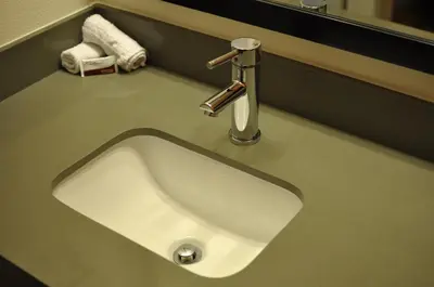 a white sink with a faucet on a bathroom counter at Motel 6 Maple/Main in Hesperia