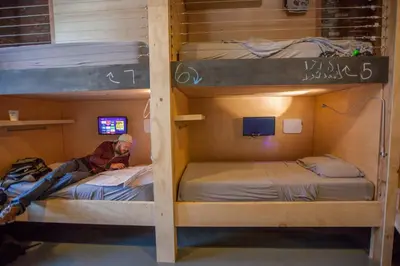 a man sitting on top of two bunk beds at PodShare DTLA in Los Angeles