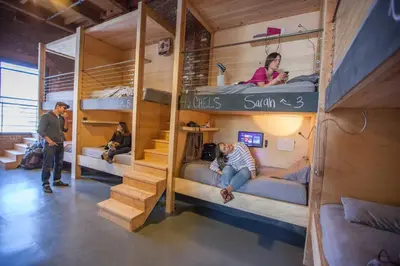 a group of people in bunk beds in a room at PodShare DTLA in Los Angeles