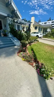 a house with a garden of flowers in the driveway at Dresden B & B in Los Angeles