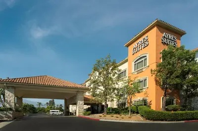 a hotel with a sign on the side of a building at Ayres Suites Ontario at the Mills Mall - Rancho Cucamonga in Ontario