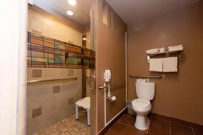 a bathroom with a toilet and a shower at Super 8 by Wyndham Anaheim/Disneyland Drive in Anaheim