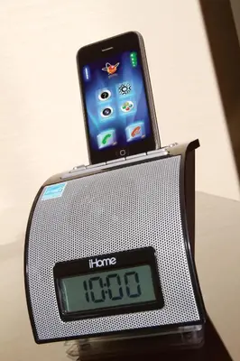 an alarm clock with a phone on top of it at Ayres Hotel Anaheim in Anaheim