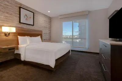 a hotel room with a bed and a television at Home2 Suites By Hilton Anaheim Resort in Anaheim