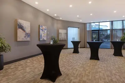 a waiting room with black tables in a building at Home2 Suites By Hilton Anaheim Resort in Anaheim