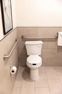 a bathroom with a white toilet in a stall at Ayres Hotel Redlands - Loma Linda in Redlands