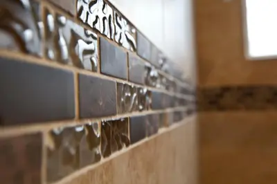 a row of tiles on the wall of a bathroom at Dunes Inn - Sunset in Los Angeles