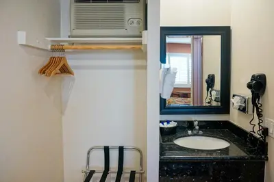 a bathroom with a sink and a mirror at Dunes Inn - Sunset in Los Angeles