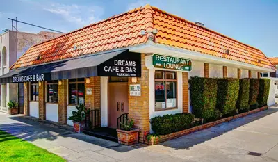 a small building with an orange roof at Dunes Inn - Sunset in Los Angeles