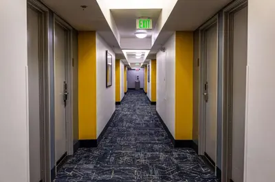 a hallway of an office building with yellow and white walls at Comfort Inn & Suites Near Universal - N Hollywood - Burbank in Los Angeles