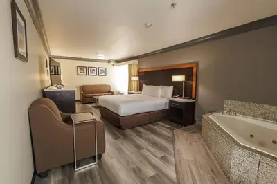 a hotel room with a bed and a bath tub at Comfort Inn & Suites Near Universal - N Hollywood - Burbank in Los Angeles