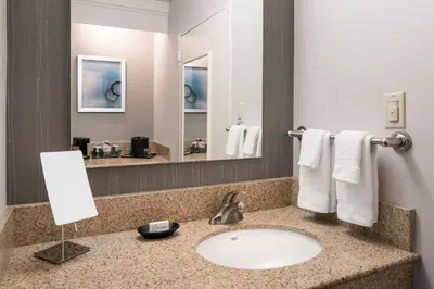 a bathroom with a sink and a mirror at Sonesta Select Los Angeles LAX El Segundo in El Segundo