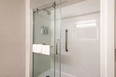 a shower with a glass door in a bathroom at Courtyard by Marriott Baldwin Park in Baldwin Park