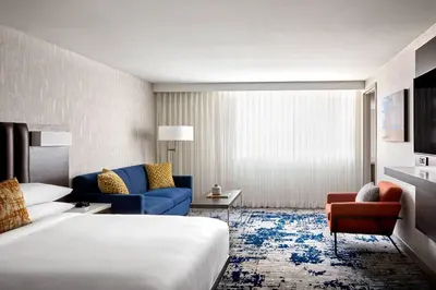 a hotel room with a bed and a couch at Ventura Beach Marriott in Ventura