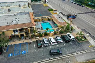 an overhead view of a parking lot with a pool at Howard Johnson by Wyndham Buena Park in Buena Park