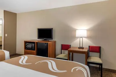 a hotel room with a bed and a flat screen tv at Quality Inn Placentia Anaheim Fullerton in Placentia