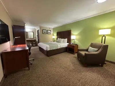 a hotel room with a bed and a chair at The Hills Inn Eagle Rock - Near Old Town Pasadena in Los Angeles