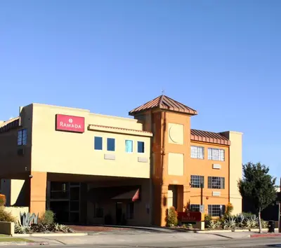 a hotel with a sign on the front of a building at Ramada by Wyndham Culver City in Los Angeles