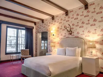 a bedroom with a large bed with pink wallpaper at Maison Twenty Seven in Los Angeles