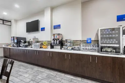 a restaurant with a long counter with a cash register at Best Western Airpark Hotel - LAX Airport LA Stadium in Inglewood