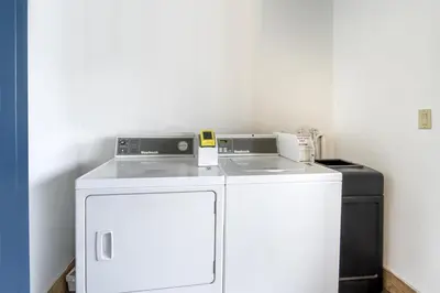 a white washer and dryer in a room at Best Western Airpark Hotel - LAX Airport LA Stadium in Inglewood