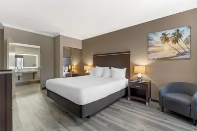 a hotel room with a bed and a chair at Best Western Redondo Beach Galleria Hotel - Beach City LA in Redondo Beach