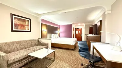a hotel room with a bed and a couch at Best Western Plus Suites Hotel - LAX Airport LA Stadium in Inglewood