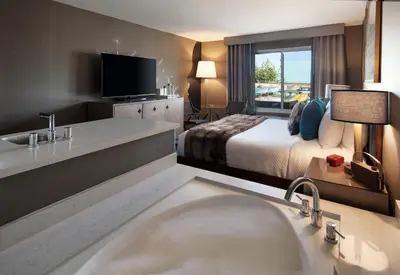 a hotel room with a bathroom with a bed and a tub at Hotel Hermosa in Hermosa Beach