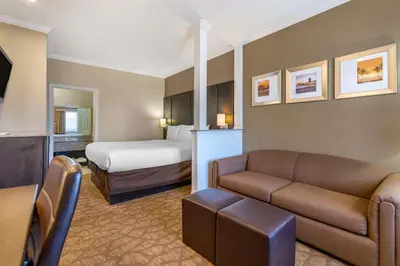 a hotel room with a couch and a bed at Comfort Inn & Suites Huntington Beach in Huntington Beach