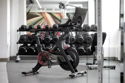 a gym with a exercise bike and dumbbell racks at Hilton Garden Inn LAX Los Angeles Airport in Los Angeles