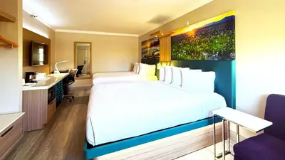 a hotel room with a large bed and a sink at Days Inn by Wyndham Los Angeles LAX South Bay Beach City LA in Lawndale