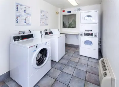 a laundry room with a washer and dryer at Motel 6-Rosemead, CA - Los Angeles in Rosemead