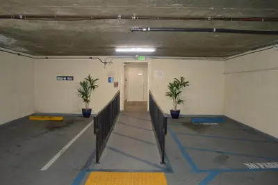 an empty room with a hallway with two plants at Jolly Roger Hotel in Los Angeles