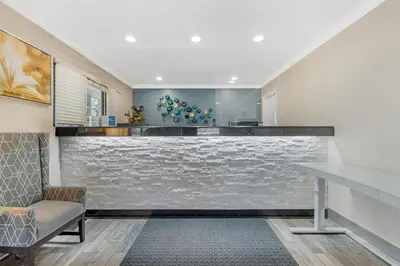 a bar in a room with a stone wall at Best Western Courtesy Hotel - Anaheim Resort Amusement Park in Anaheim